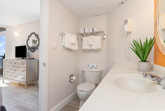 bathroom with hardwood / wood-style floors, vanity, and toilet