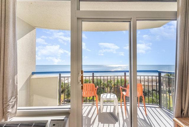 balcony with a water view and a beach view