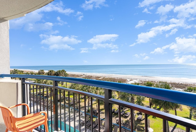 balcony with a water view and a beach view