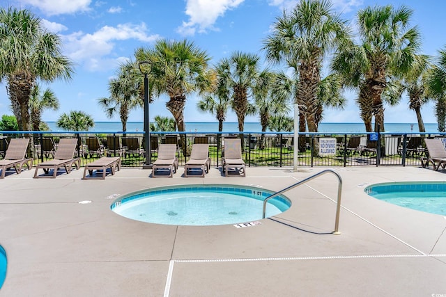 view of pool with a water view