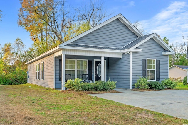 view of front facade with covered porch and a front yard