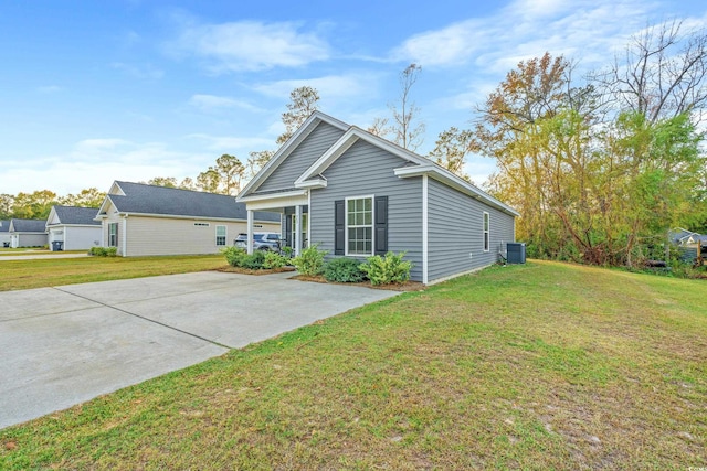 exterior space with central AC unit and a yard