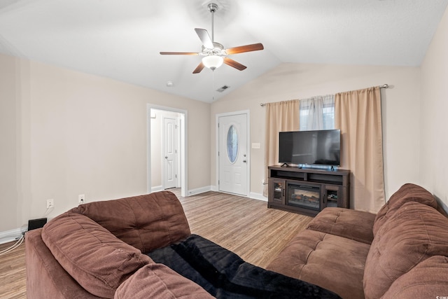 living room with light hardwood / wood-style floors, ceiling fan, and lofted ceiling