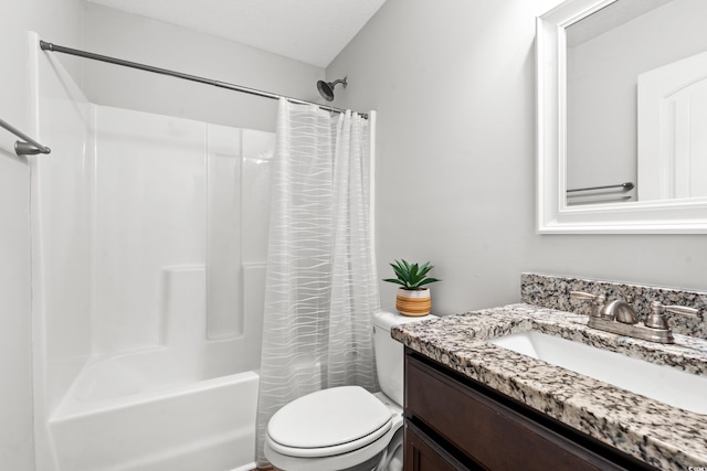 full bathroom featuring vanity, shower / bath combination with curtain, and toilet