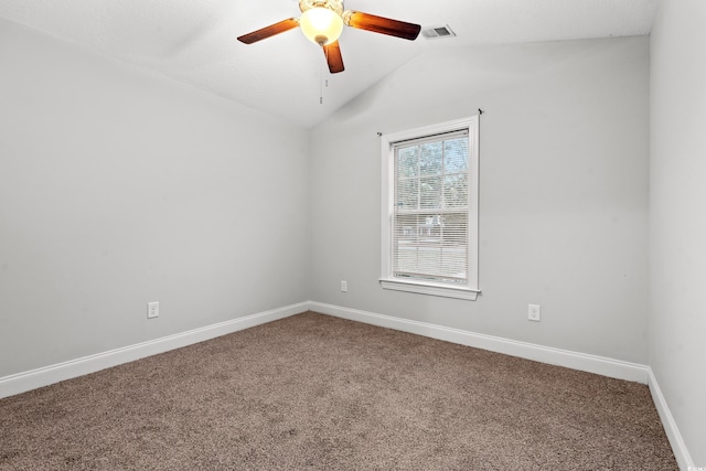 empty room with ceiling fan, lofted ceiling, and carpet floors