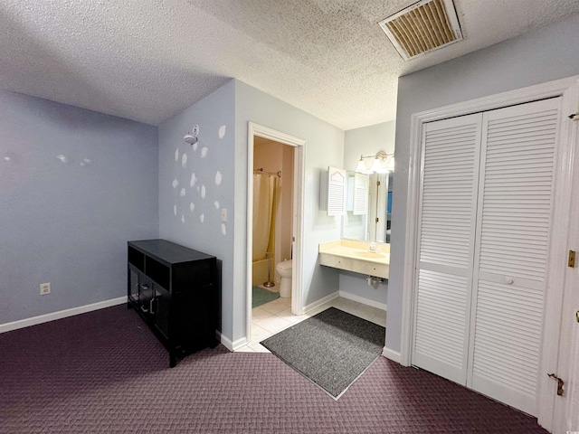 bathroom with toilet and a textured ceiling