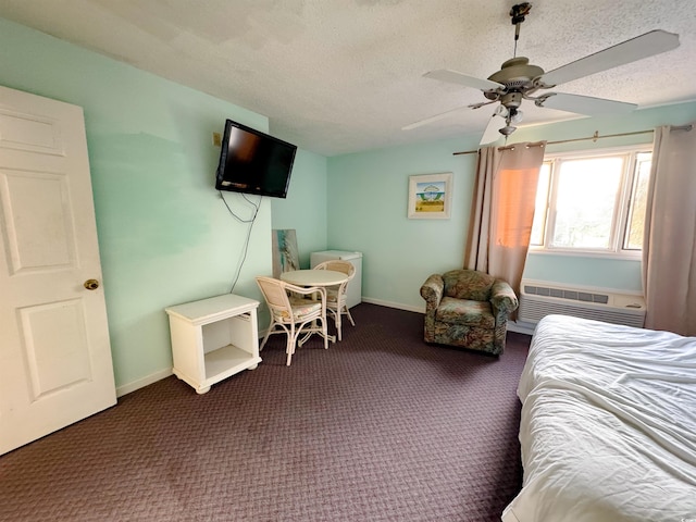 carpeted bedroom featuring a wall unit AC, ceiling fan, and a textured ceiling