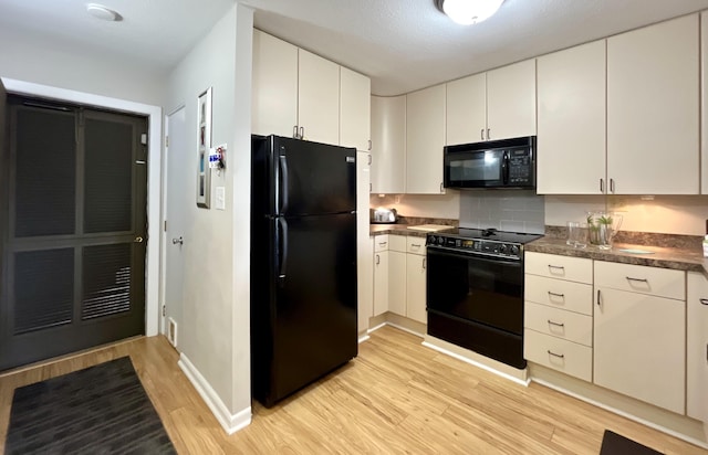 kitchen with white cabinetry, light wood-type flooring, and black appliances