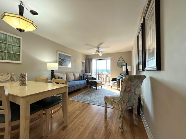 living room with hardwood / wood-style floors and ceiling fan