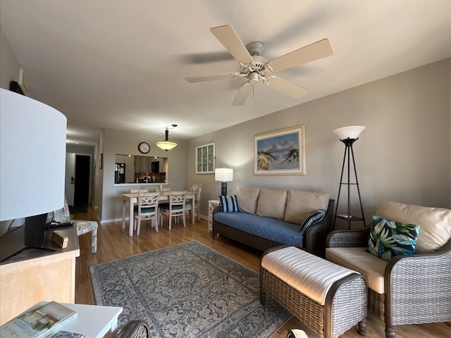 living room with wood-type flooring and ceiling fan