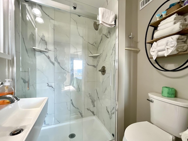 bathroom with sink, an enclosed shower, and toilet