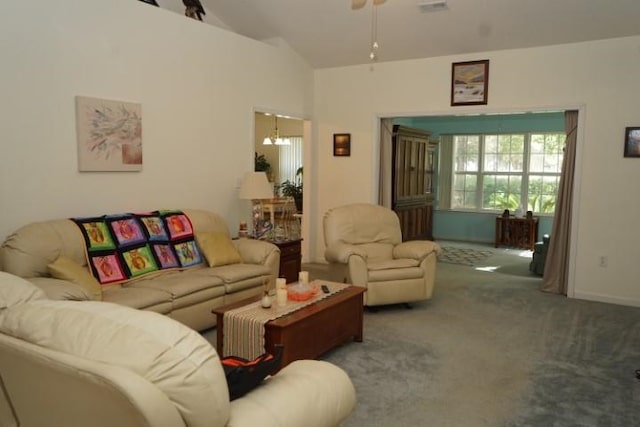 carpeted living room with vaulted ceiling and ceiling fan with notable chandelier