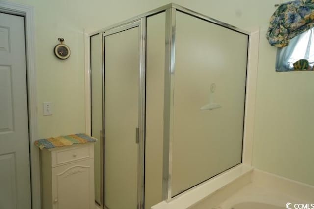 bathroom with a shower with door