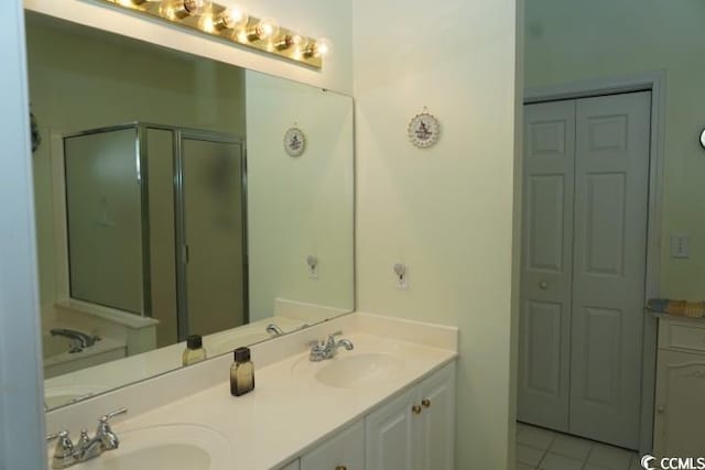 bathroom with vanity, tile patterned flooring, and an enclosed shower