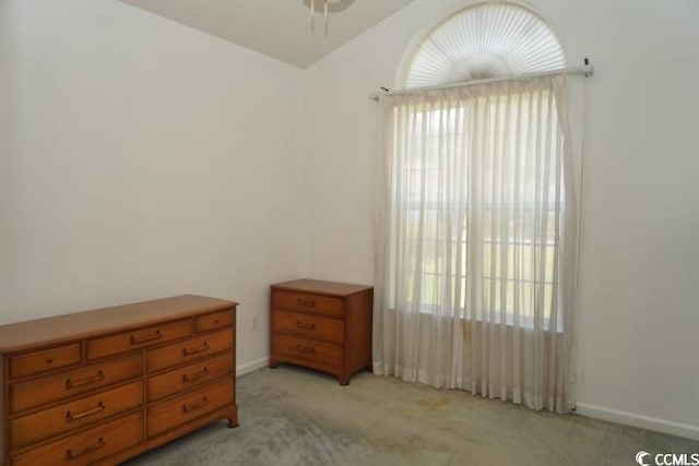 bedroom featuring light carpet and multiple windows