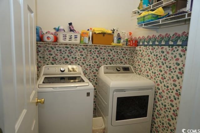 washroom with washing machine and clothes dryer