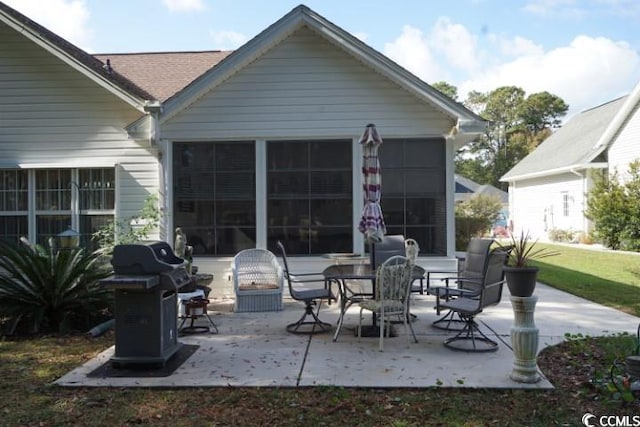 rear view of house with a patio and a sunroom