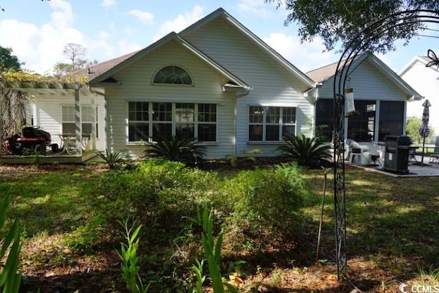 rear view of property with a patio area and a lawn