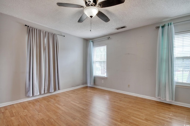 4337 Spa Dr Unit 1309, Little River, SC 29566 - spare room featuring a textured ceiling, light wood finished floors, plenty of natural light, and ceiling fan