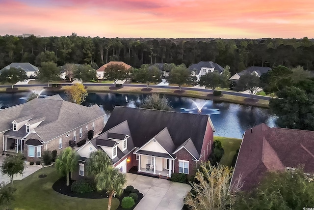 aerial view at dusk with a water view