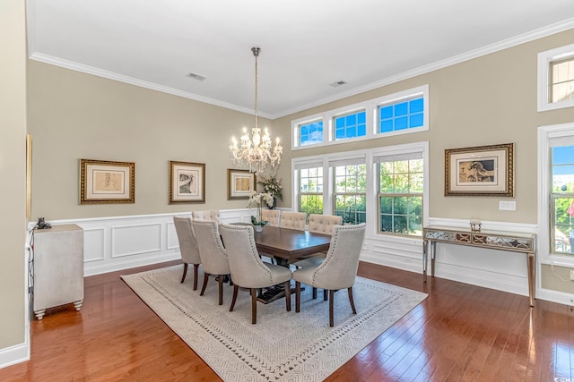 dining space featuring dark hardwood / wood-style flooring, a towering ceiling, ornamental molding, and a wealth of natural light