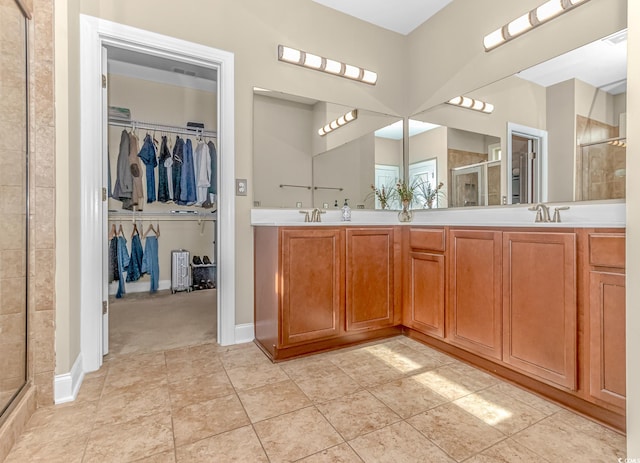 bathroom featuring vanity, walk in shower, and tile patterned flooring