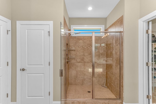 bathroom featuring a shower with shower door