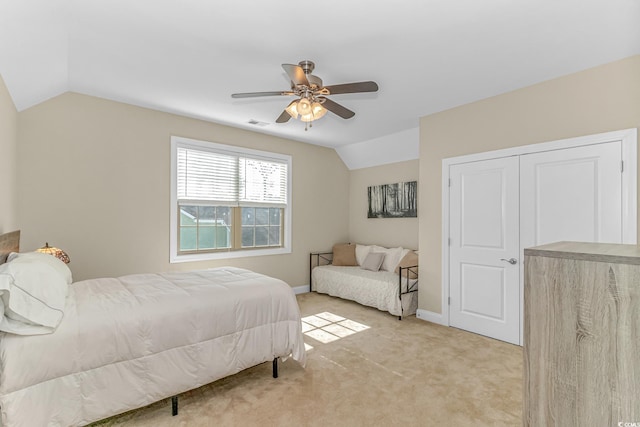 bedroom featuring light carpet, lofted ceiling, and ceiling fan