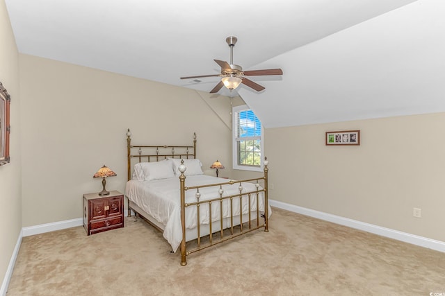 carpeted bedroom featuring lofted ceiling and ceiling fan