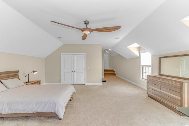 carpeted bedroom featuring a closet, ceiling fan, and lofted ceiling