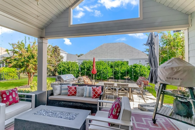 view of patio / terrace featuring area for grilling and an outdoor living space with a fire pit