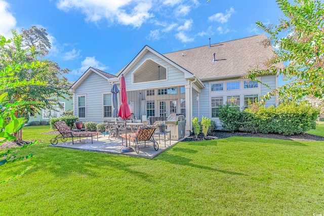 back of house with a patio and a yard