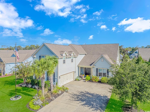 view of front of house featuring a front yard and a garage