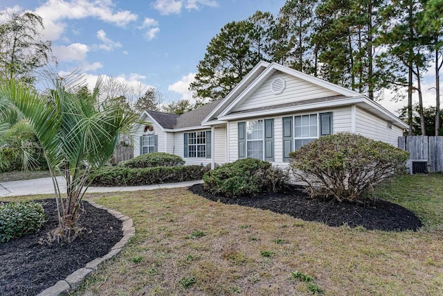 view of front of property with central AC and a front yard