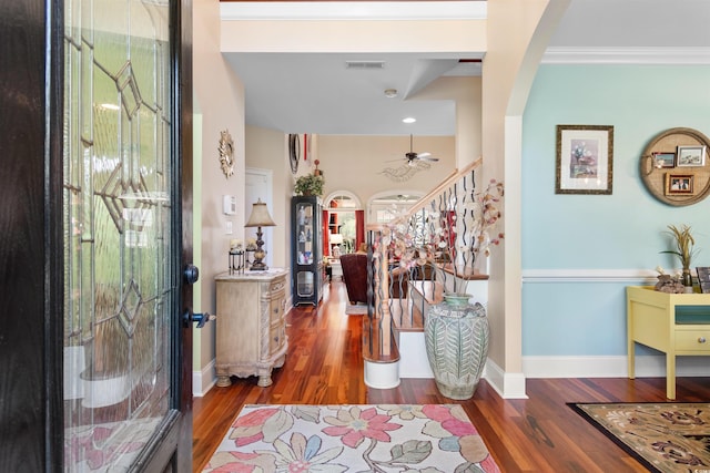 entryway featuring ornamental molding, dark hardwood / wood-style flooring, and ceiling fan