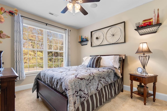 bedroom with light colored carpet and ceiling fan