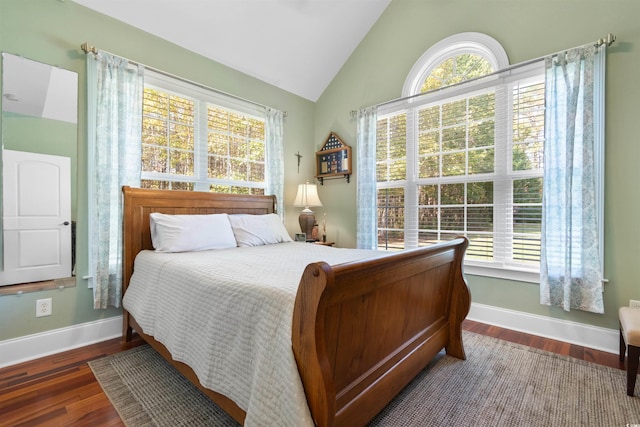 bedroom with dark wood-type flooring and vaulted ceiling