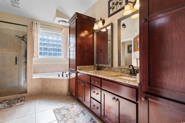 bathroom with tile patterned flooring, vanity, and shower with separate bathtub