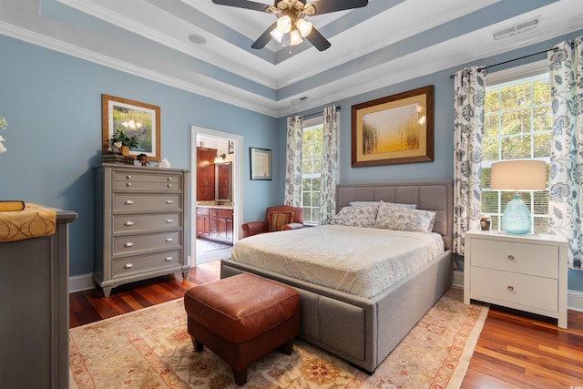 bedroom featuring ornamental molding, hardwood / wood-style floors, ceiling fan, and ensuite bathroom