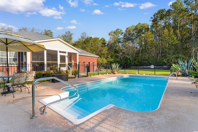 view of pool with a patio and a sunroom