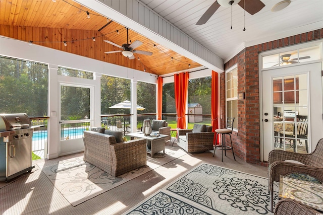 sunroom / solarium with wooden ceiling, a pool, and vaulted ceiling with beams