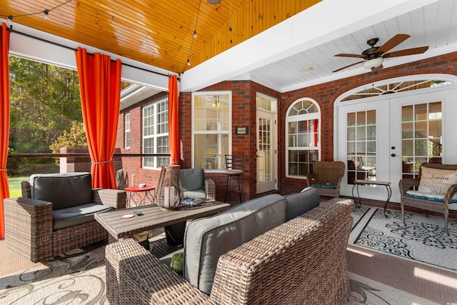 sunroom / solarium featuring french doors, wooden ceiling, ceiling fan, and plenty of natural light