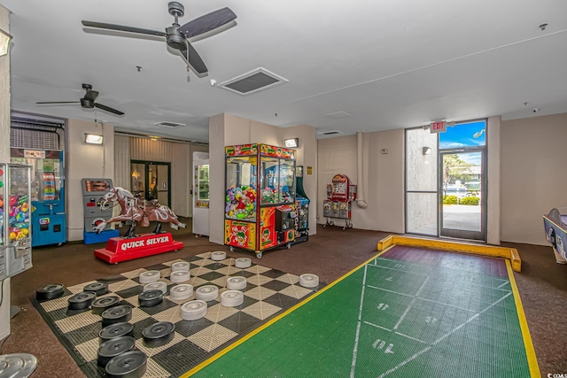 rec room featuring ceiling fan and dark colored carpet