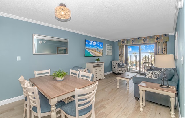 dining room with ornamental molding, a textured ceiling, and light hardwood / wood-style flooring