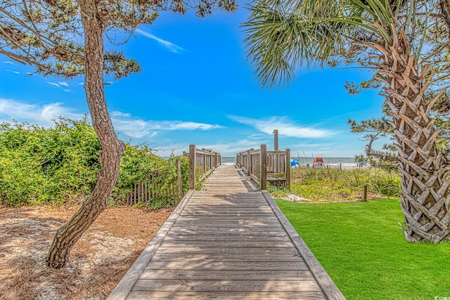 surrounding community featuring a lawn and a water view