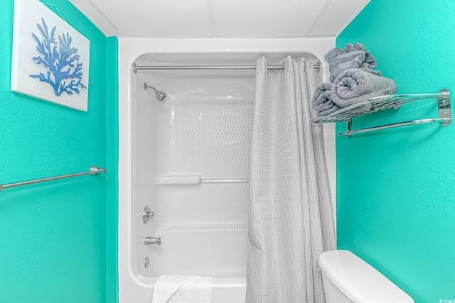 bathroom featuring shower / bath combo and toilet