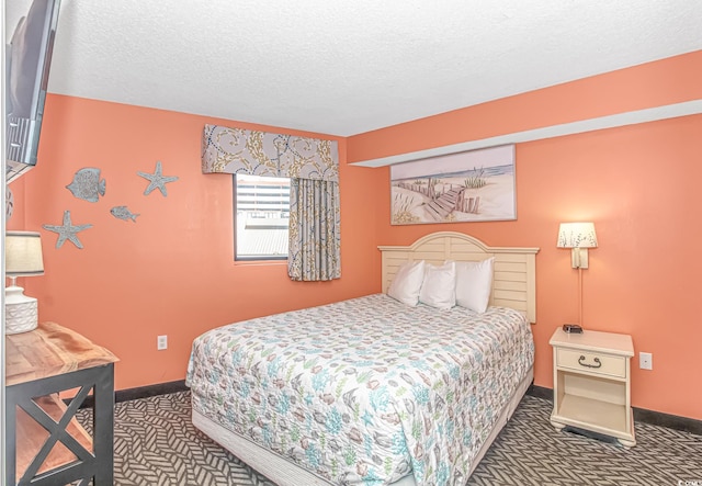 carpeted bedroom featuring a textured ceiling