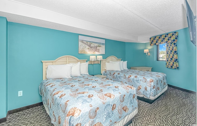 bedroom with a textured ceiling and carpet floors