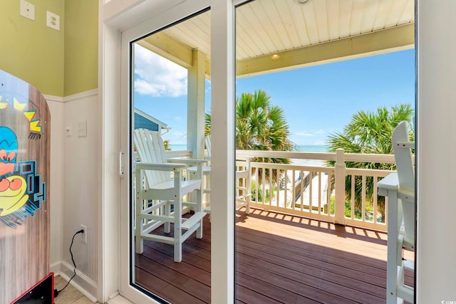 doorway to outside featuring a water view and wood-type flooring