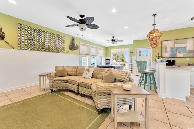 living room with ceiling fan and light tile patterned floors